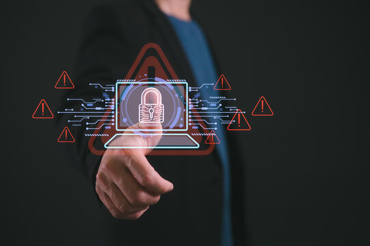 Businessman pointing at diagram or icon show cyberattack warning concept digital red alert icons symbolizing system hack, data breaches financial threats identity theft in a high-risk tech space