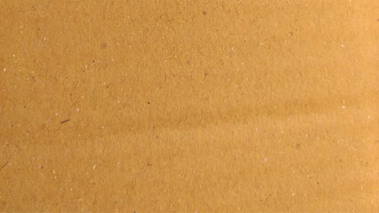 Background of brown kraft paper or cardboard texture. Old vintage paper with a glowing center and grunge vignette.