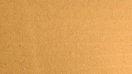 Background of brown kraft paper or cardboard texture. Brown kraft paper texture macro closeup with grains texture.