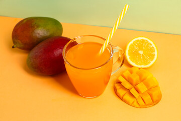 Glass of fresh mango smoothie on color background