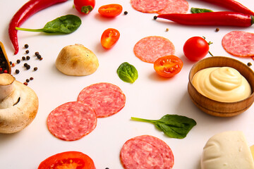 Fresh ingredients for preparing pizza on white background