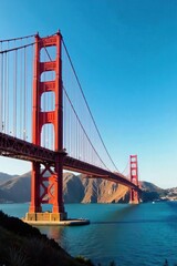 Fototapeta premium Majestic Golden Gate Bridge at Sunset Iconic San Francisco Bay Landmark, Vibrant Orange Towers, Clear Blue Sky, Stunning Seascape Vista