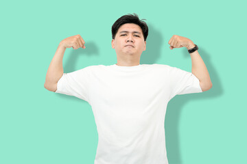Fototapeta premium Man Flexing Biceps: Asian Man Showing Off Muscles