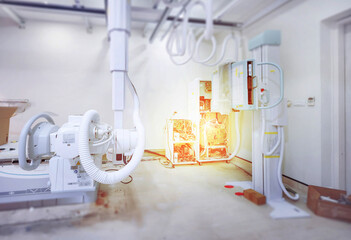 A high-tech X-ray machine in a medical room, featuring advanced equipment and intricate wiring. It’s ready to provide clear and detailed imaging for diagnostics.
