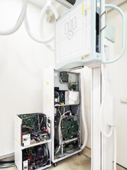 A high-tech X-ray machine in a medical room, featuring advanced equipment and intricate wiring. It’s ready to provide clear and detailed imaging for diagnostics.
