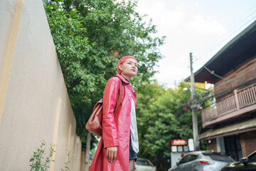 Gen z girl leather fashion with punk Asian woman tourist of local city Southeast Asia travel trendy...