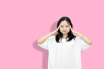 Asian Teenager Girl in a Thinking Pose, Hand on Chin, Pink Background