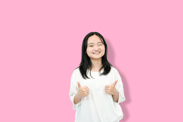cute asian girl giving thumbs up for your victory and accomplishment
