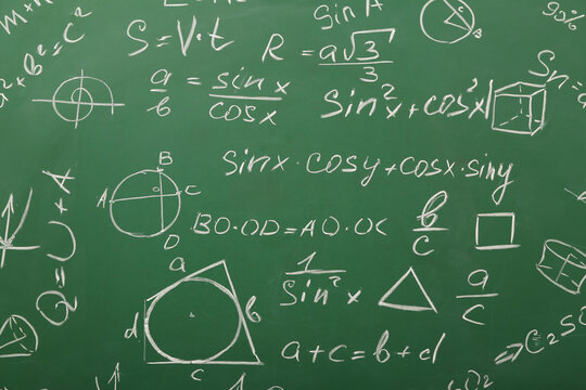 Different drawn geometric figures and math formulas on green chalkboard