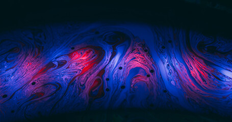 Soap colorful chaos. Defocused paint blend. Vibrant wave curl liquid. Red blue gradient fluorescent mix gasoline flare abstract black background.