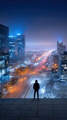 Cityscape at night, figure on rooftop