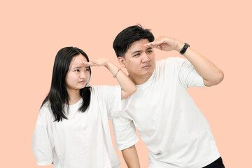 Young Couple Looking Intently, Studio Shot