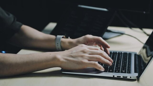 Male programmer working on new project.He working late at night at the office.