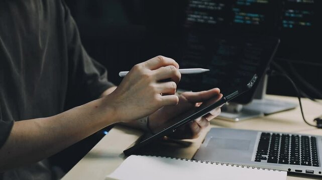 Male programmer working on new project.He working late at night at the office.