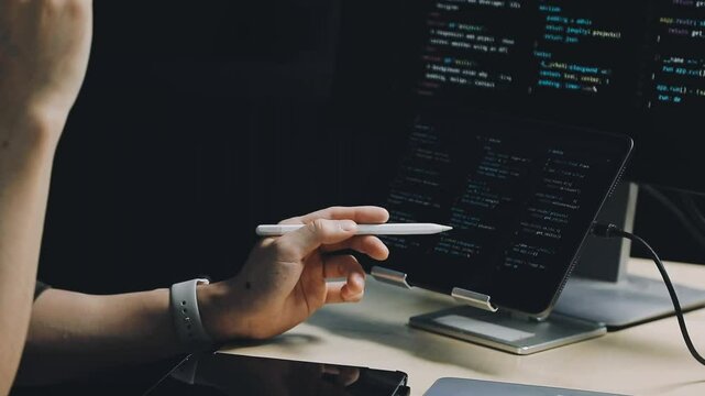 Male programmer working on new project.He working late at night at the office.