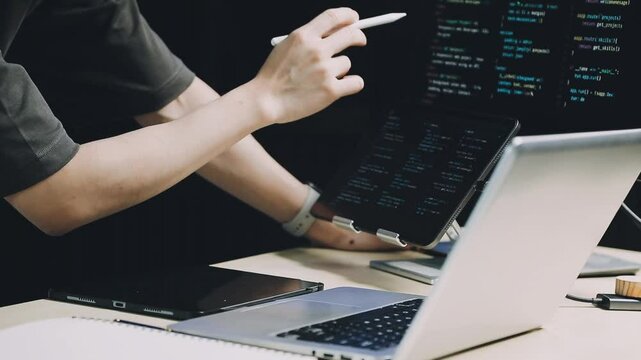 Male programmer working on new project.He working late at night at the office.