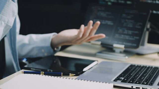 Male programmer working on new project.He working late at night at the office.