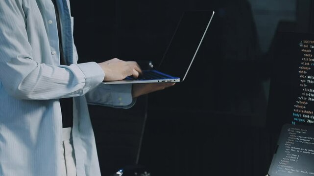 Male programmer working on new project.He working late at night at the office.