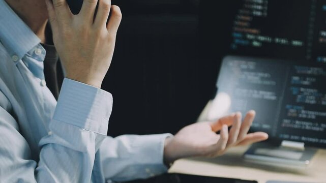 Male programmer working on new project.He working late at night at the office.
