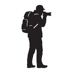 Silhouette of a photographer exploring and capturing pictures outdoors with a camera and backpack