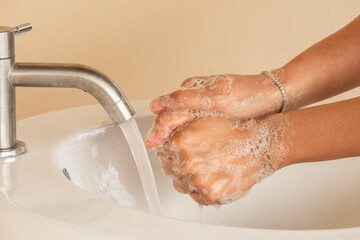 hand of beauty woman wash your hands at the wash basin with foam, cleanse the skin and have water...