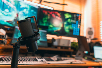 Fototapeta premium Modern podcast setup with professional microphone on boom arm in cozy home studio, featuring blurred monitors and wooden blinds background. Creative workspace inspiration.