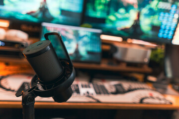 Modern podcast setup with professional microphone on boom arm in cozy home studio, featuring blurred monitors and wooden blinds background. Creative workspace inspiration.