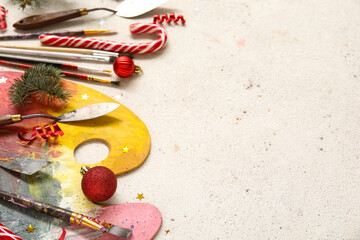Composition with painter's tools and Christmas decorations on light background