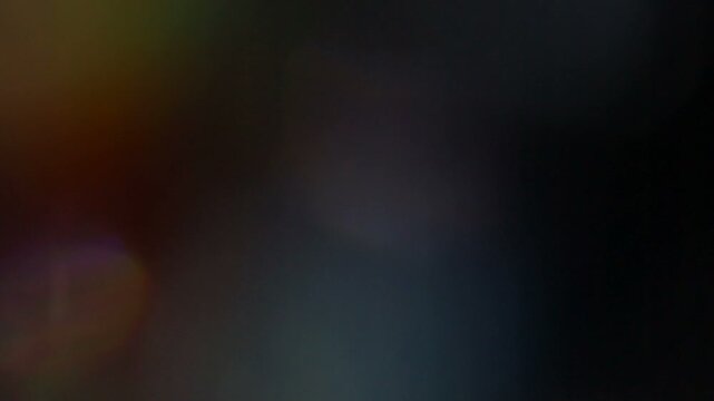 A beautiful, organic, and cinematic light leak and lens flare overlay with colorful rainbow refractions, perfect for adding a dreamy, vintage, or atmospheric effect