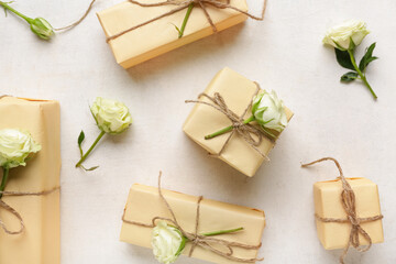 Many gift boxes with beautiful roses on white background. International Women's Day