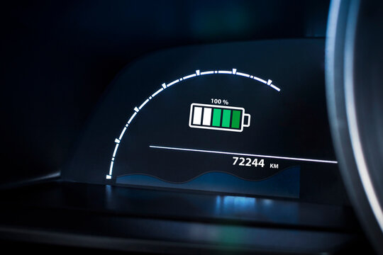 Electric vehicle dashboard showing a 100% battery fully charge. EV, green energy, sustainable transport technology.