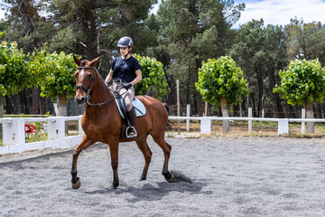 girl training horse in outdoor riding arena
