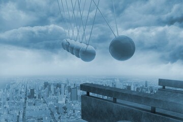 Newtons cradle above city