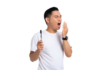Portrait of young Asian man in white t-shirt checking his breath, blowing into hand, bad smell from...