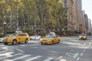 Flat design showing sunlit city intersection with moving yellow taxi cabs and road markings