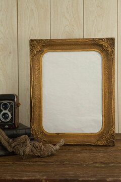 Photo frame and camera on table