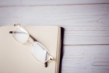Eyeglasses on textured wooden table