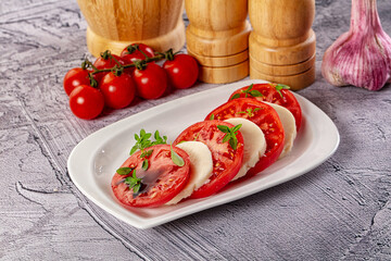 Italian caprese salad with mozzarella, tomato and basil