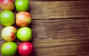 Red and green apples on table