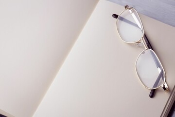 Golden eyeglasses on book