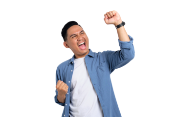 Big win. Excited young Asian man in casual shirt celebrating success with raised fist isolated on transparent background
