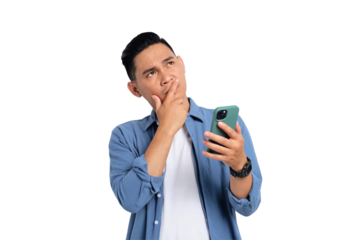 Pensive young Asian man in casual shirt holding smartphone, looking aside at copy space, thinking about offer isolated on transparent background