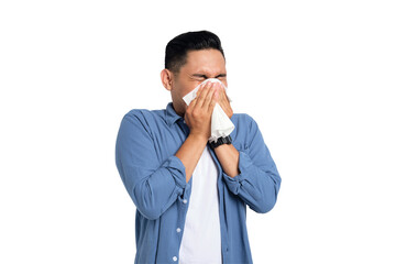 Unhealthy young Asian man in casual shirt blowing nose in paper tissue isolated on transparent...
