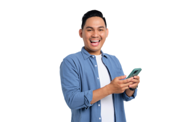 Smiling young Asian man in casual shirt using smartphone, chatting online, texting message, looking at camera isolated on transparent background