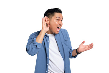 Can't hear you. Curious young Asian man in casual shirt holding hand near ear, trying to listen to...
