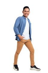 Full length of smiling young Asian man in casual shirt walking with hand in pocket and confidently looking at camera isolated on transparent background