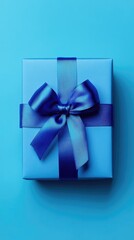   Blue gift box with blue bow on blue background 