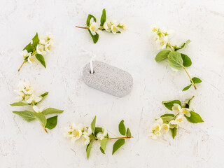 Body care products and branches of jasmine on the white background.