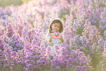The children girl of vast flower field in full bloom stretches.