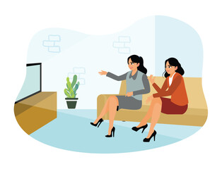 Two female friends relaxing on the couch and watching television at home.